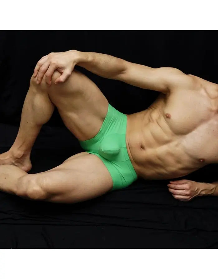 Green boxer underwear made of soft material featuring a snug fit shown on a model by Arroyman.