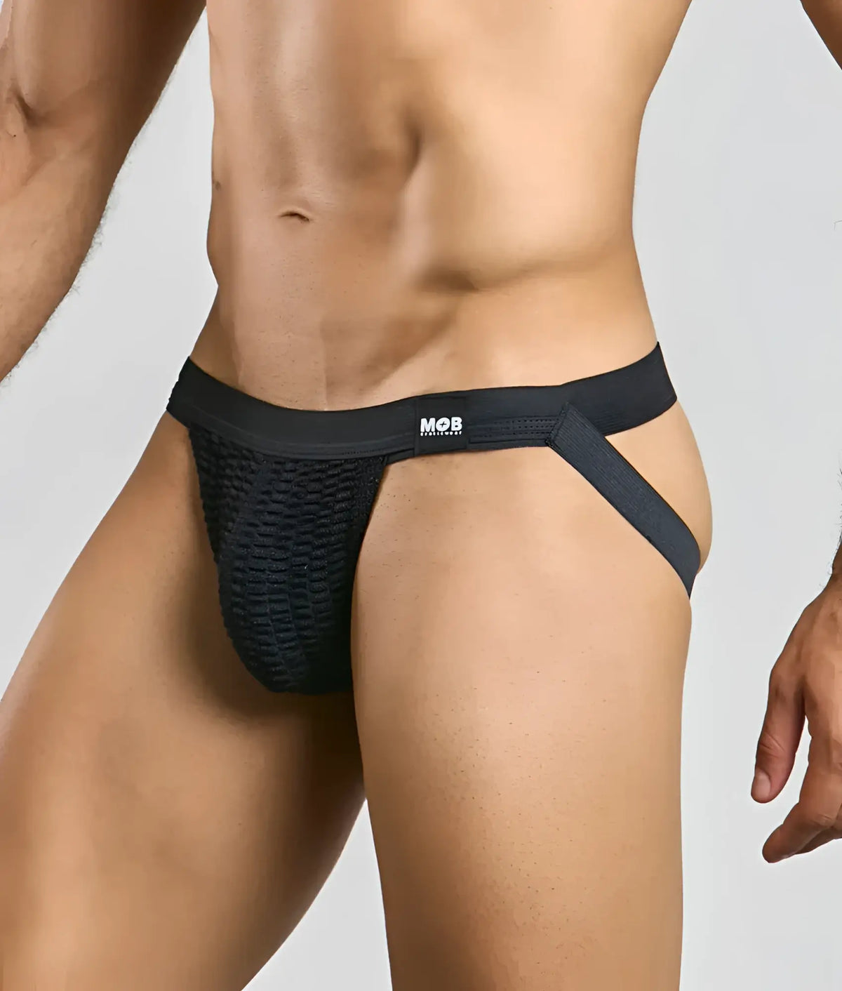 Black mesh mob swim jockstrap briefs with supportive elastic waistband and side straps featuring mob logo