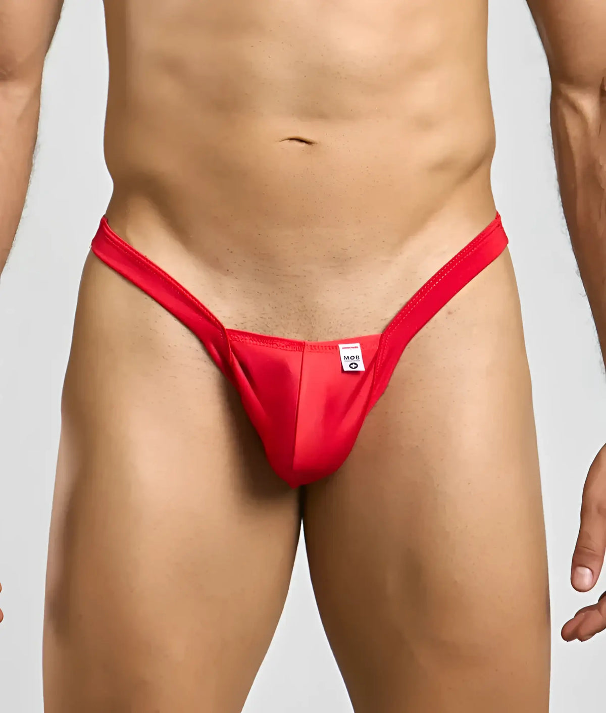 Red thong mob y buns thong with a small white tag at the center front made from soft breathable fabric