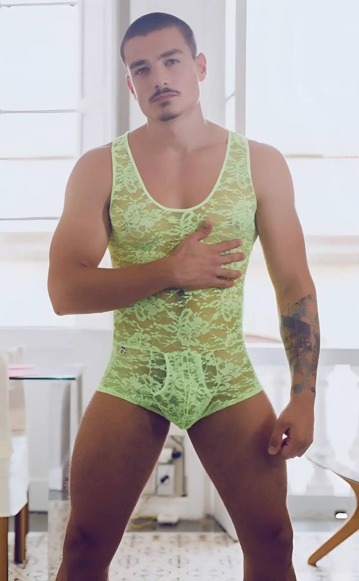 Lime green lace bodysuit with intricate floral patterns from MOB men designed for a stylish fit