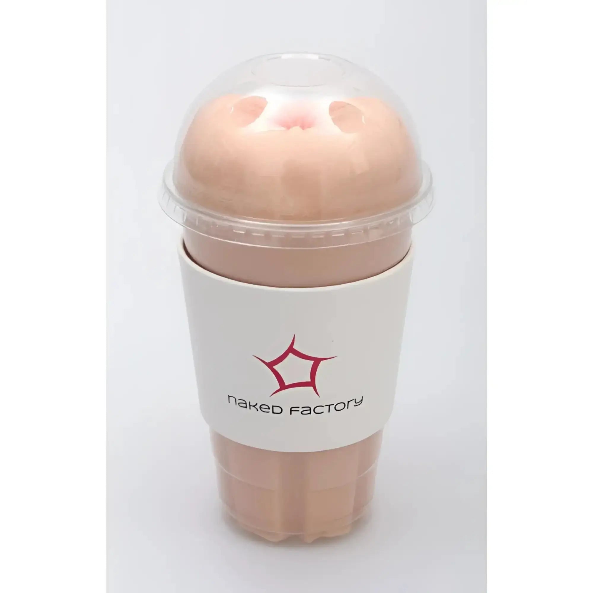 A peach-colored silicone anal masturbator resembling a cup with clear lid and white naked factory logo sleeve