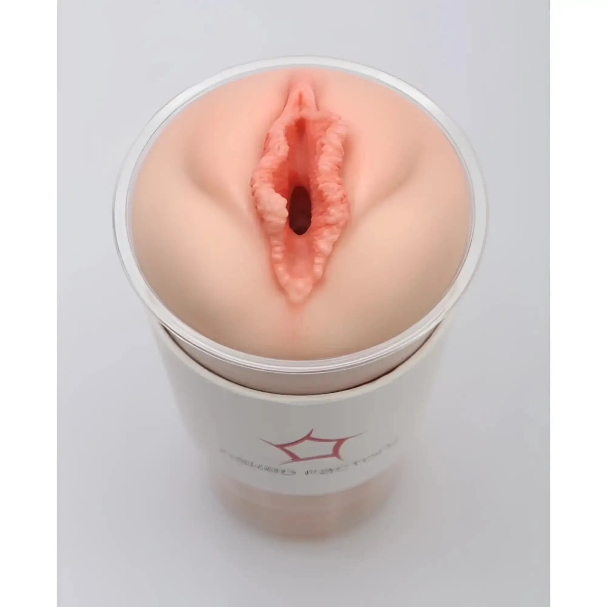 Peach-colored silicone anal plug in clear cylindrical container for naked factory pussy masturbator blair product