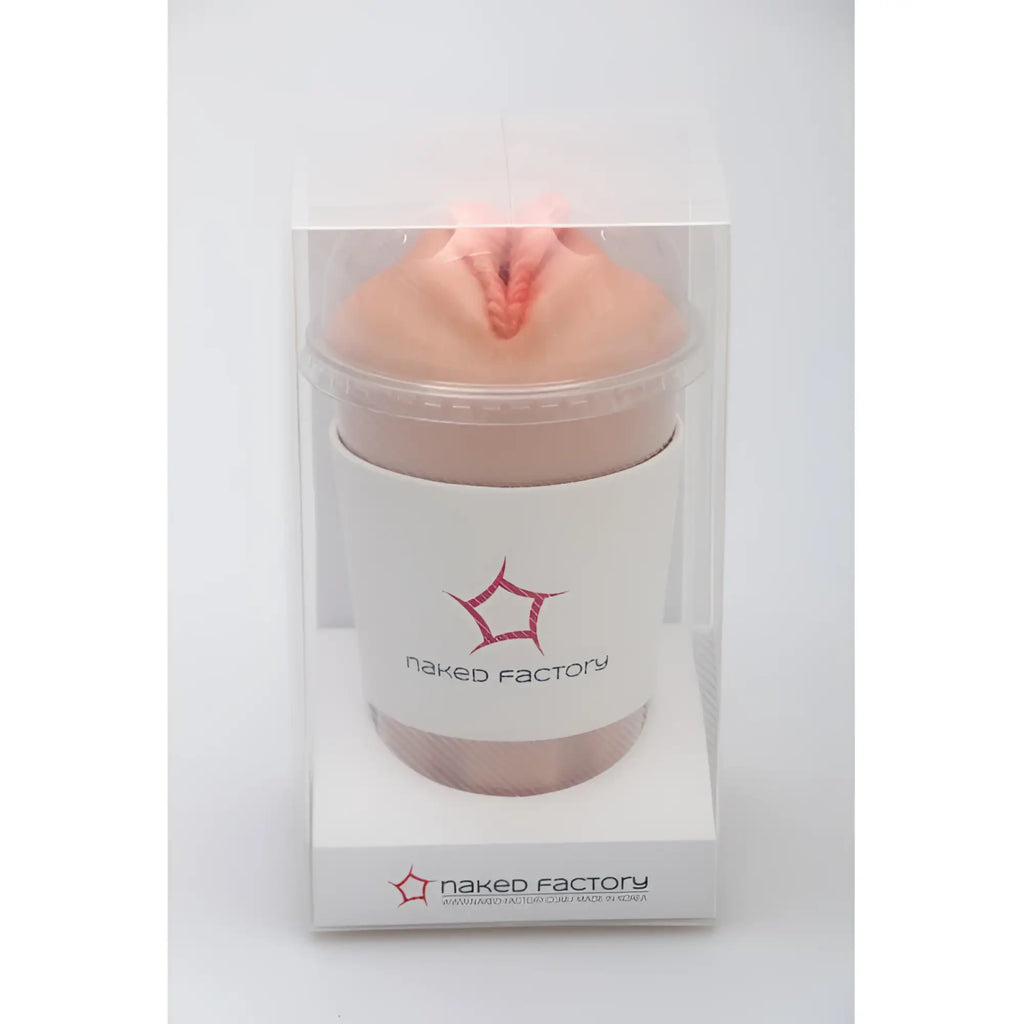 A peach-colored silicone textured naked factory pussy masturbator dani with central opening and subtle red detailing in clear packaging