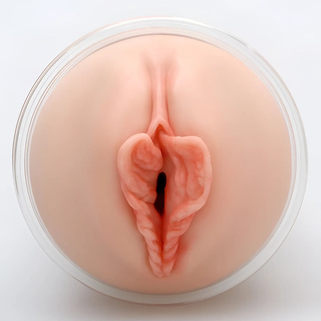 A realistic flesh-toned silicone anal plug with textured interior and central opening from naked factory pussy masturbator dani