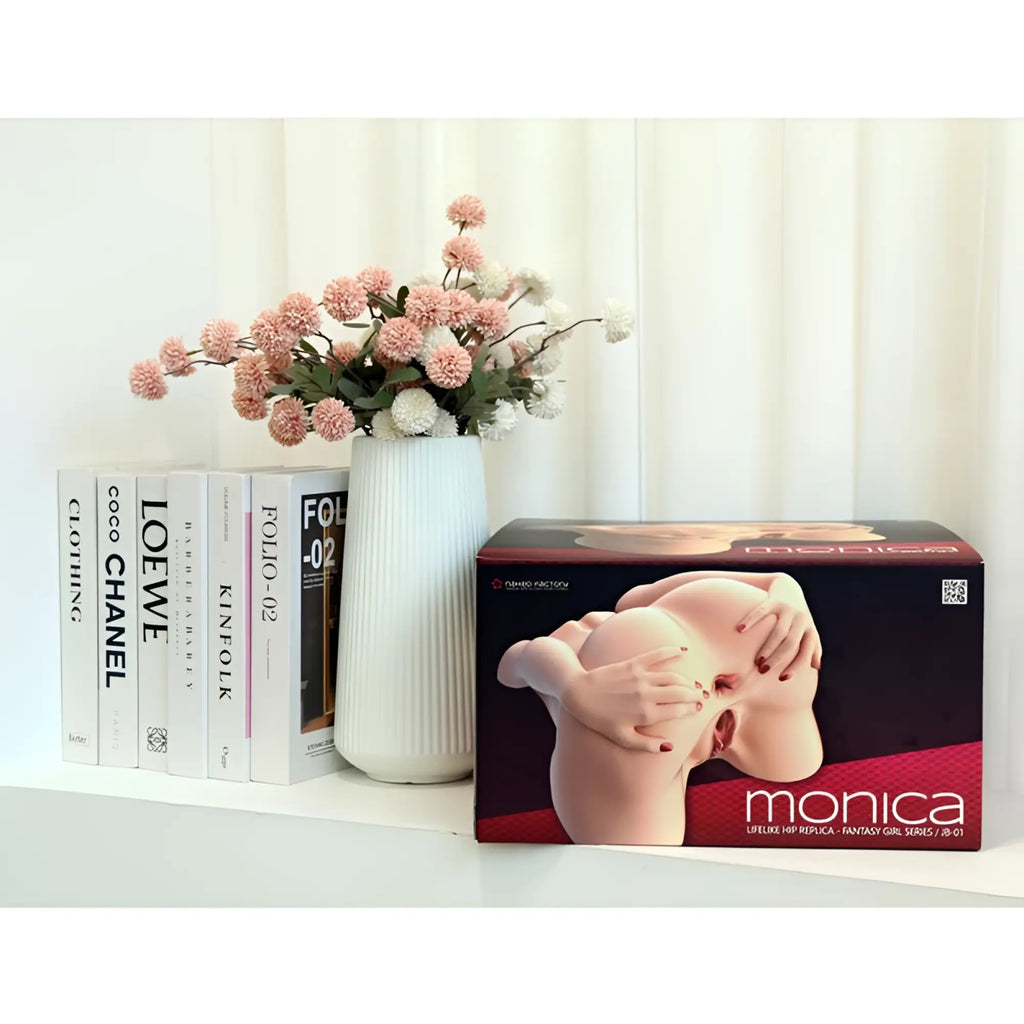 White ribbed ceramic vase holding pink and white artificial flowers beside naked factory spread me pussy and anal masturbator torso monica