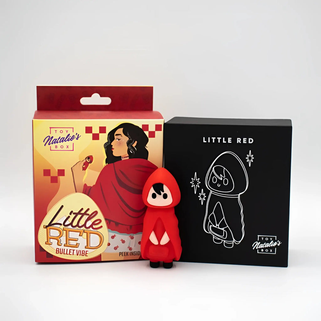A vibrant red glossy plastic natalies toy box little red bullet vibrator with white triangular accents on the hood and chest