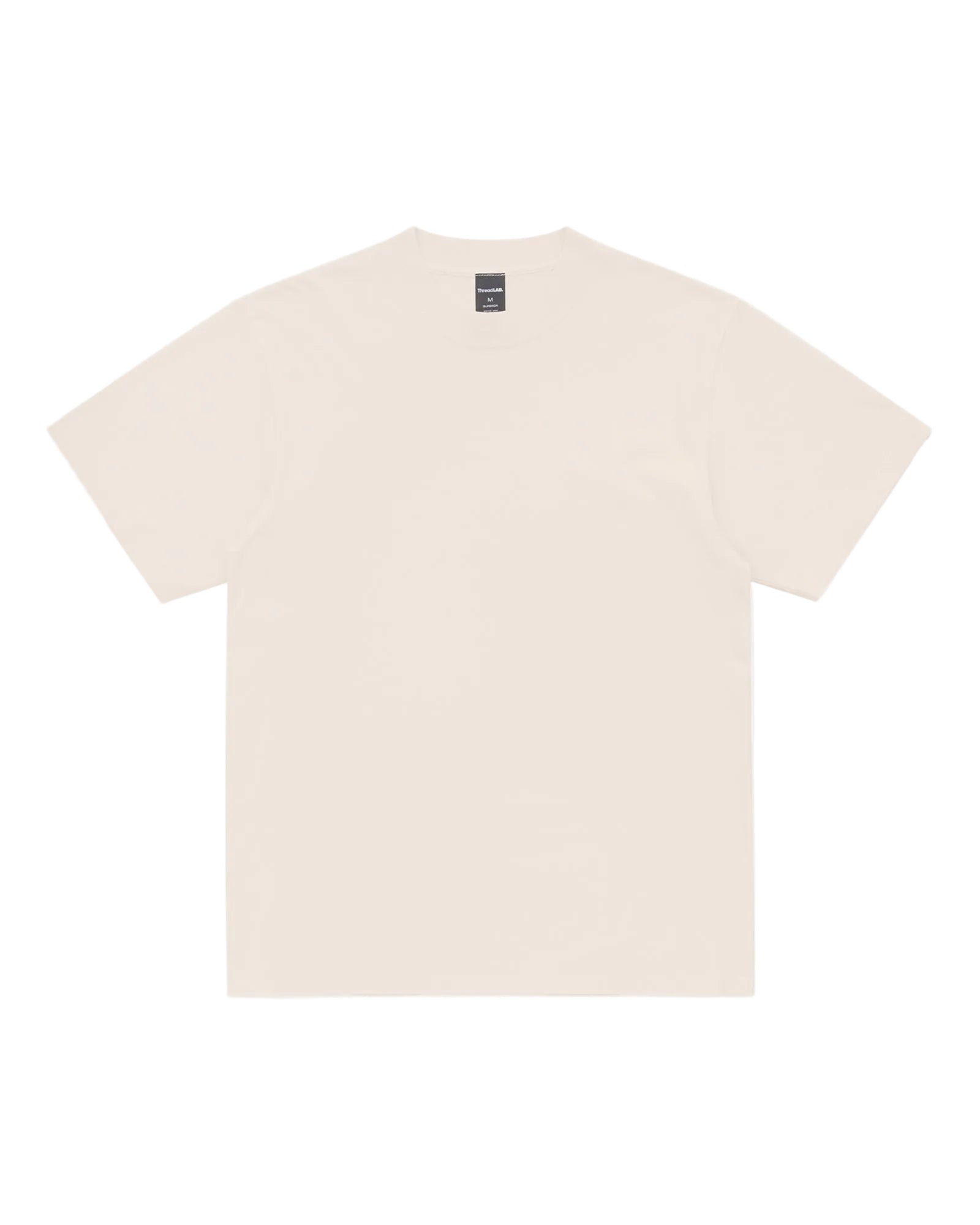 A plain cream-colored short-sleeve Superior Tee with a crew neck and a visible brand tag on the inner collar.