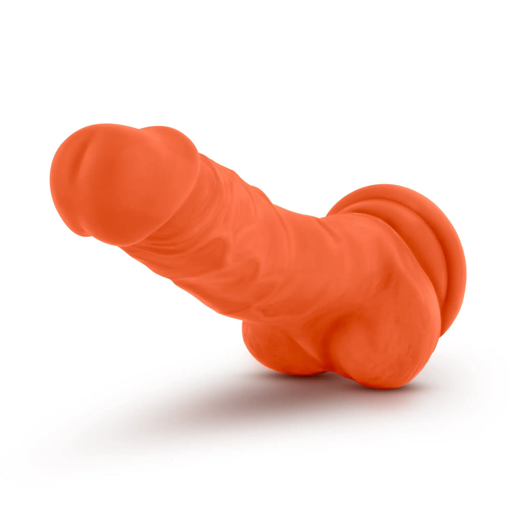 Orange silicone Neo Elite 7.5in dual density cock with textured surface and rounded contours, neon orange color