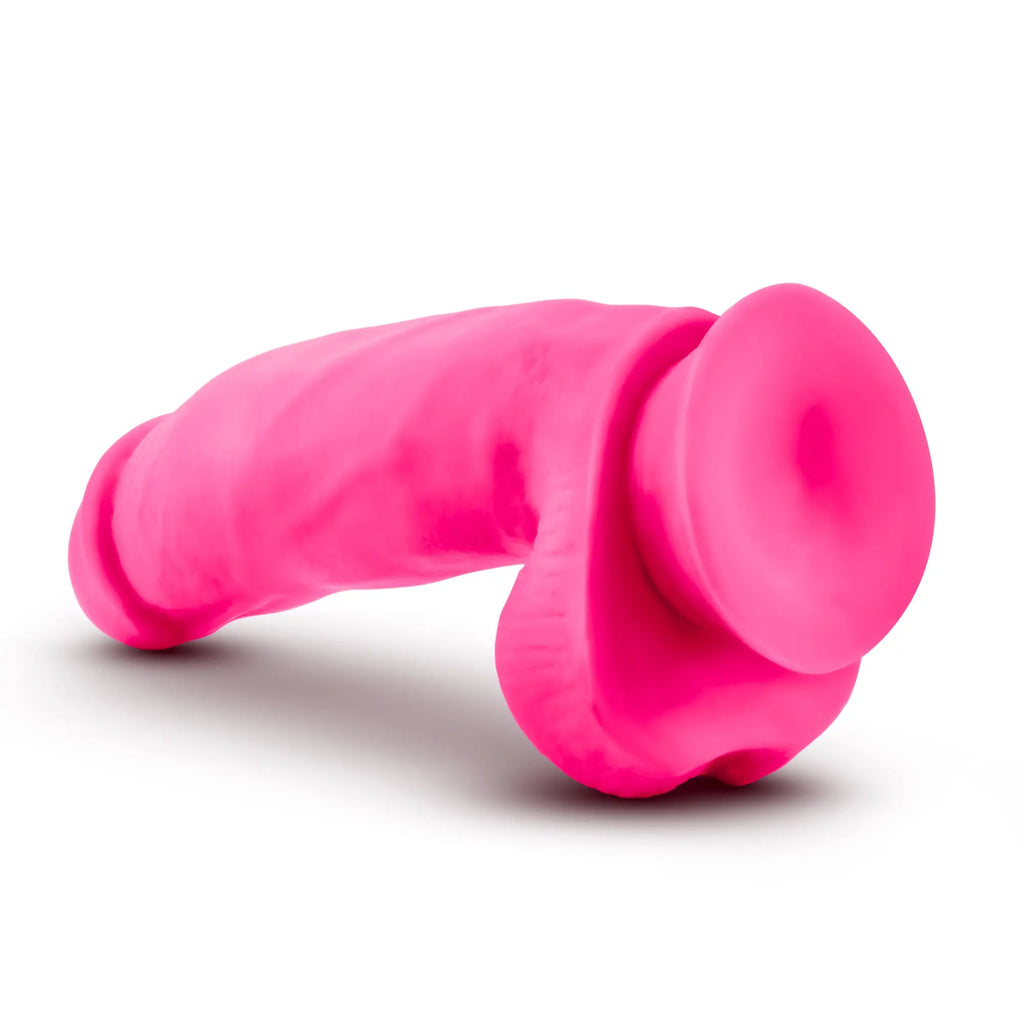 Neo Elite 7in silicone dual density cock with balls in neon pink featuring a bright pink silicone suction cup end