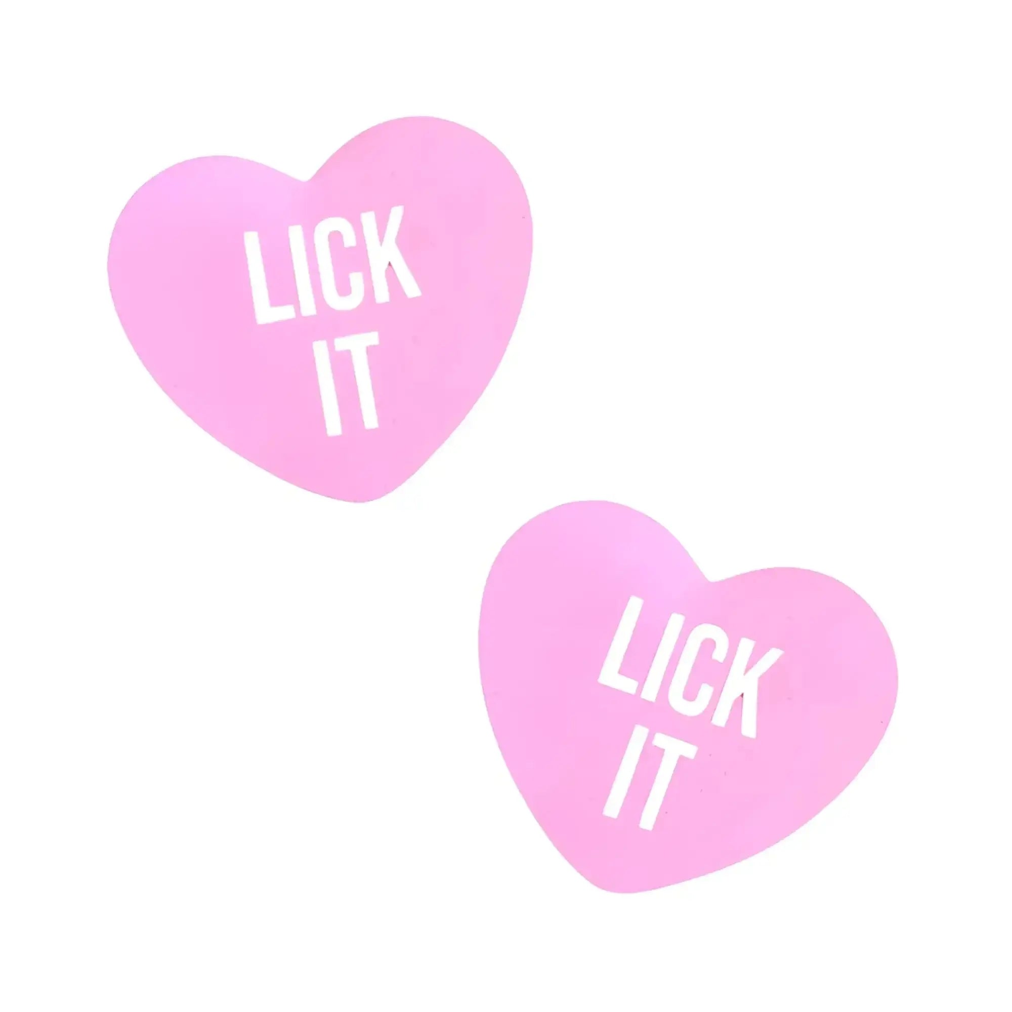 Pink heart-shaped candy stickers with lick it printed in white from neva nude lick it love heart pasties collection