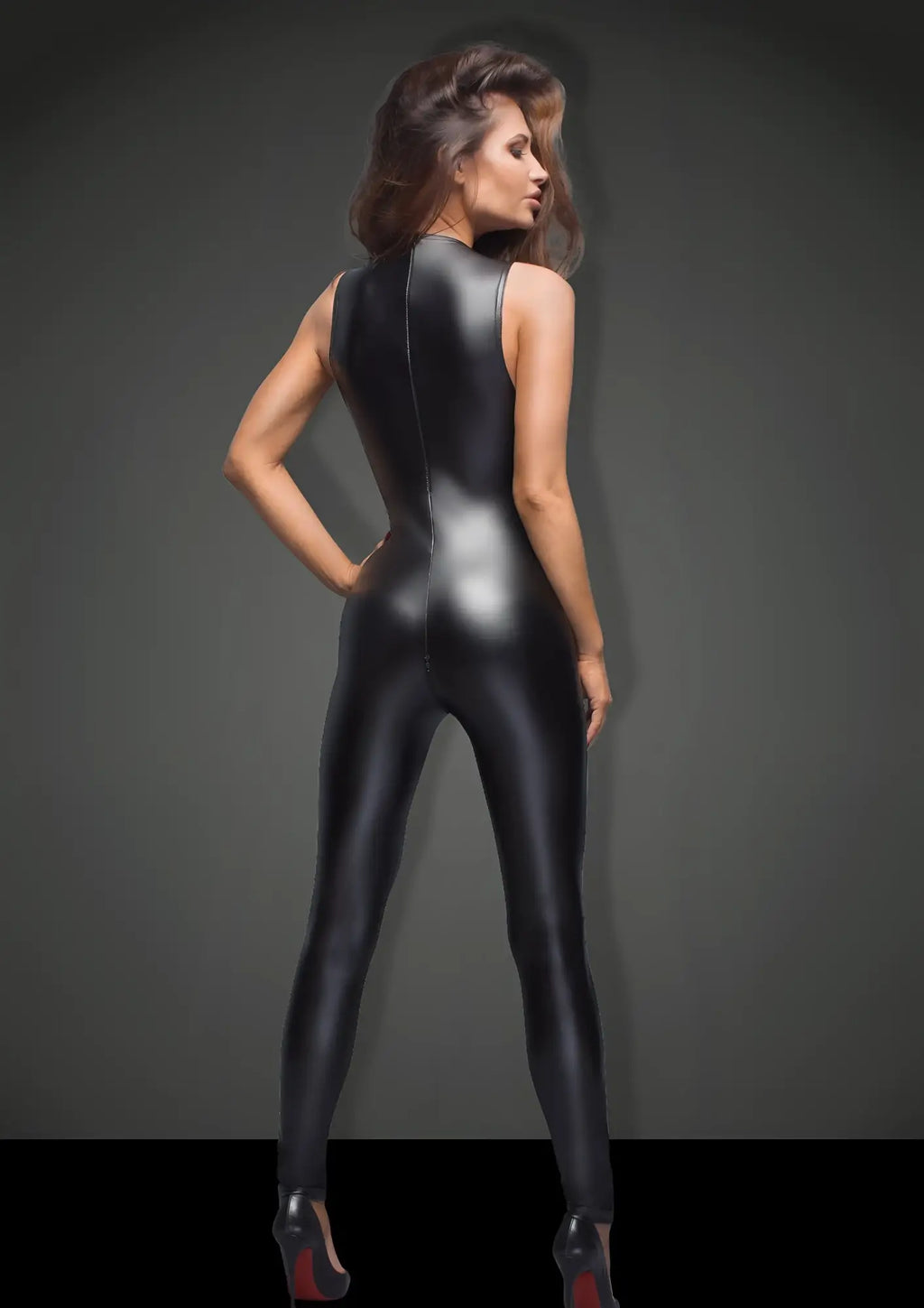 Black glossy latex catsuit with high neckline and back seam shown from the back in noir sleeveless power wetlook overall with lace s