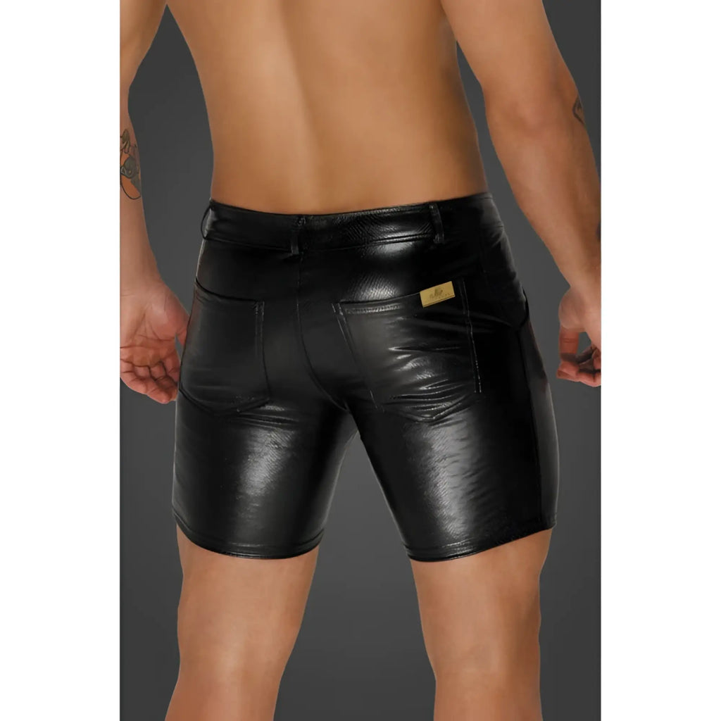 Back view of black shiny faux leather noir snake wetlook mid length shorts with back pockets and gold brand tag
