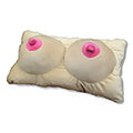 Beige plush novelty boobs pillow designed to resemble breasts with pink embroidered nipples for humorous decor
