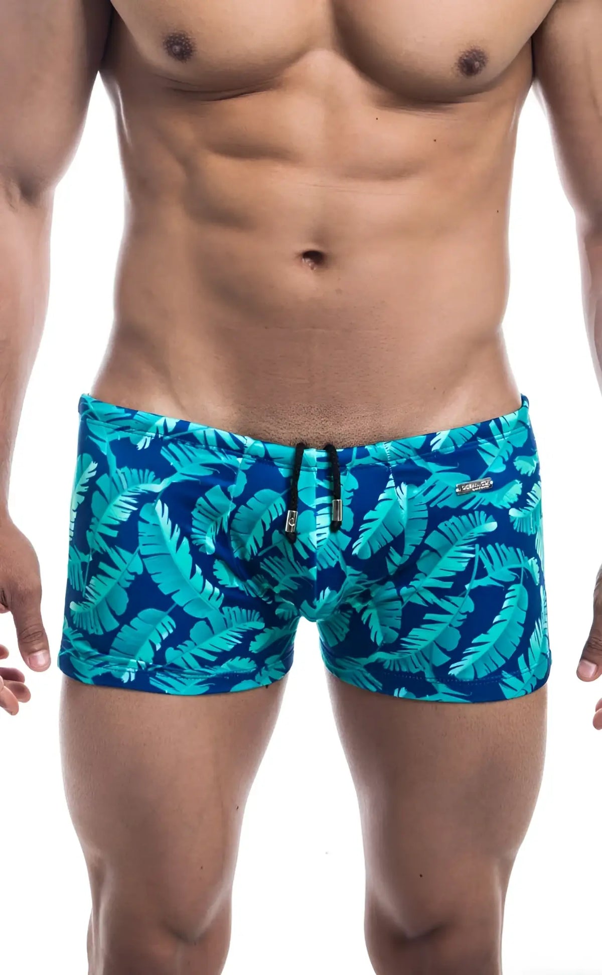 Blue swim trunks oceanico square cut with vibrant turquoise tropical leaf pattern ideal for beachwear