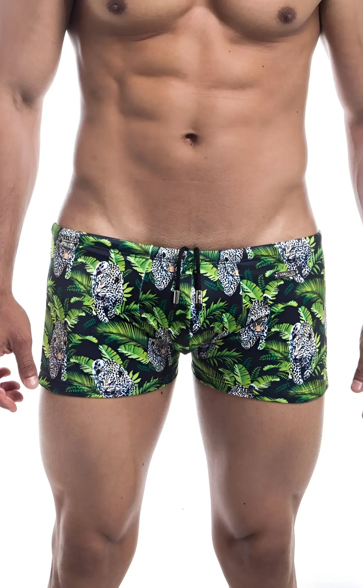 Oceanico square cut swim trunks in green and black with bold tropical palm leaves and white jaguar pattern