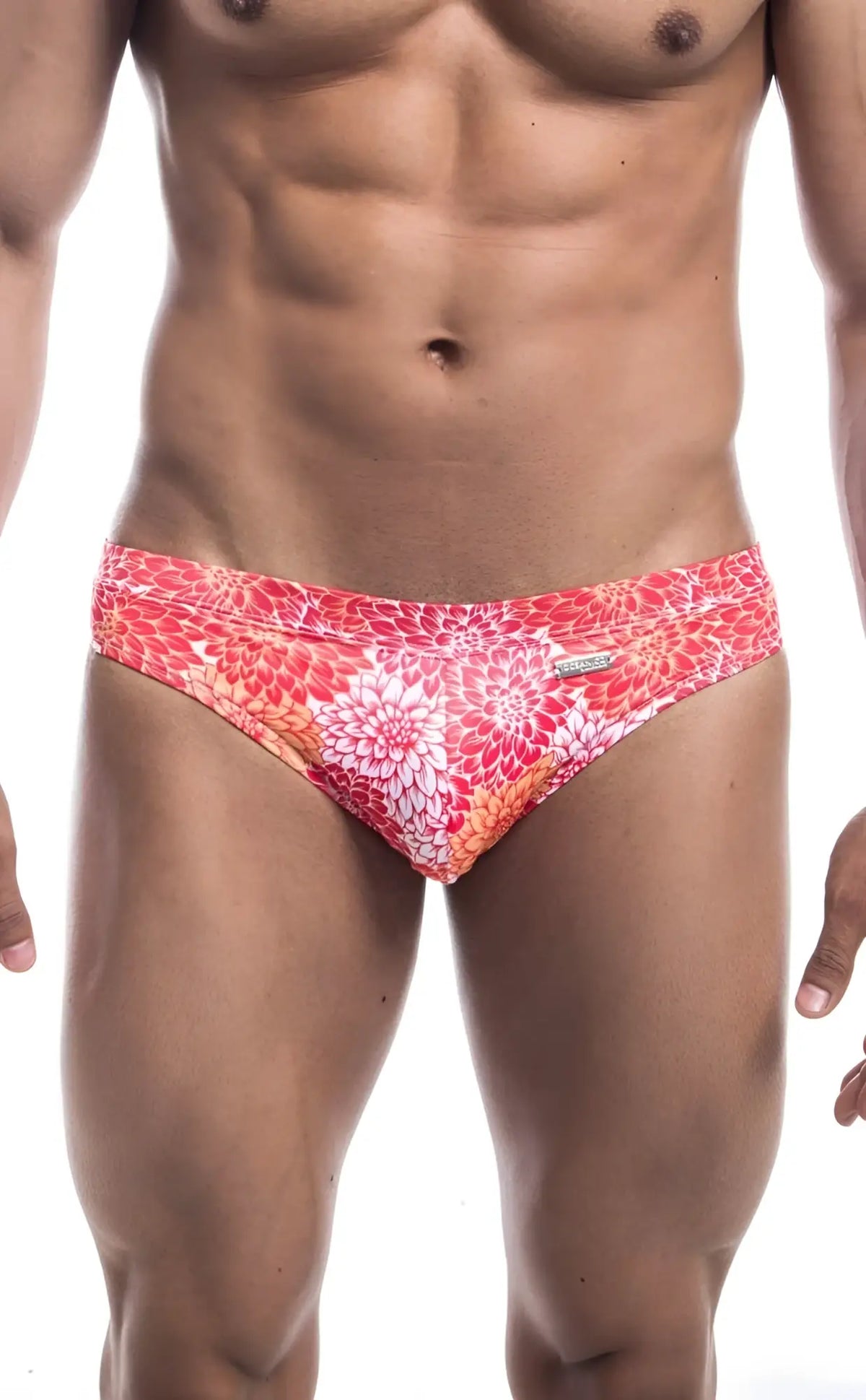 Oceanico swim bikini featuring vibrant coral and white floral-patterned swim trunks with a sleek modern design