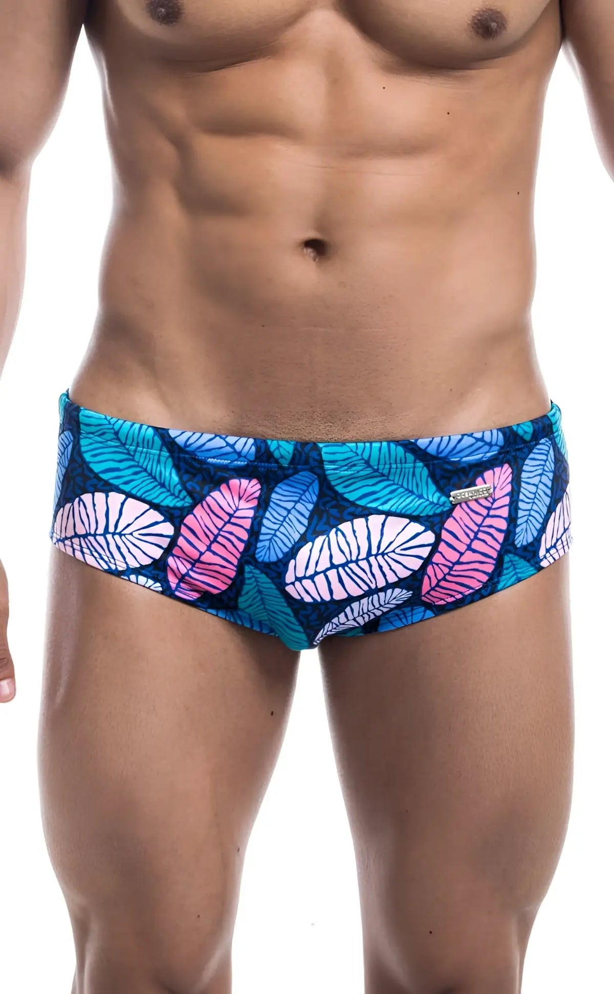 Oceanico swim brief featuring vibrant tropical leaf-patterned swim trunks in teal pink and white on a dark blue base