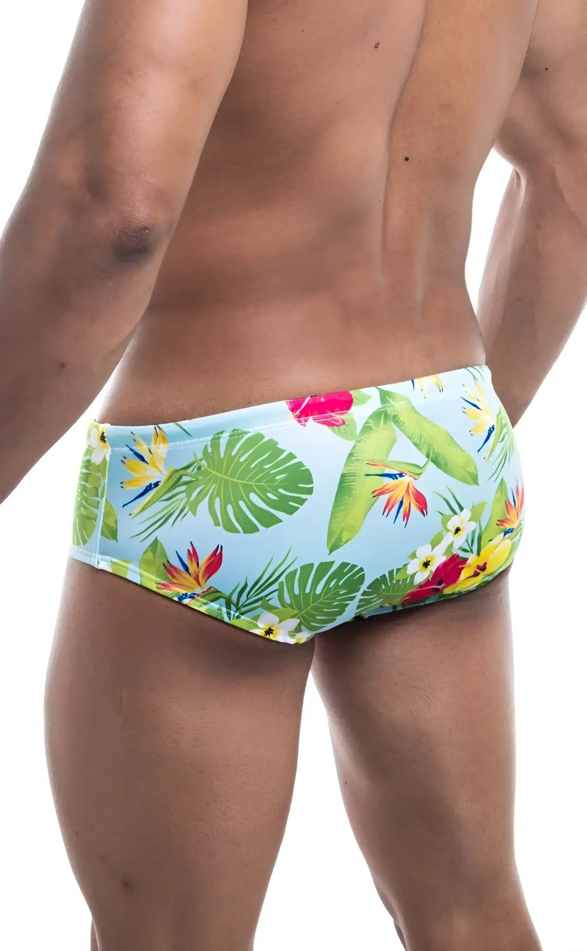 Oceanico swim brief in light blue with tropical print featuring green monstera leaves and red yellow flowers