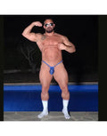 Blue ribbed G-string thong underwear by Arroyman featuring a bulge design worn by a model by a pool.