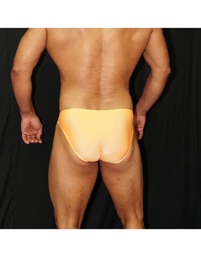 Men's orange bikini swimwear by Arroyman featuring a snug fit and smooth fabric shown from the back on a model.