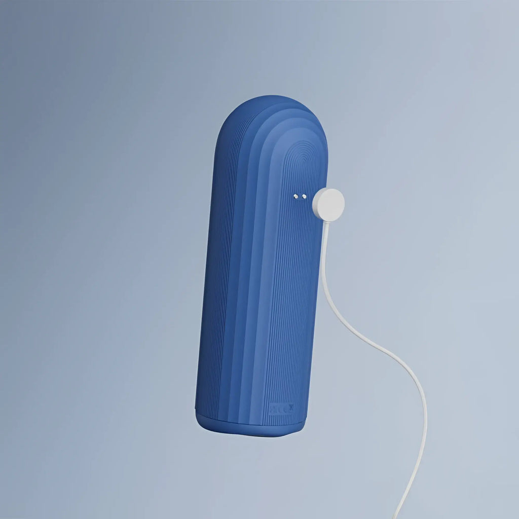Blue ribbed portable speaker with white charging cable attached for OTouch submarine submersible vibrating masturbator