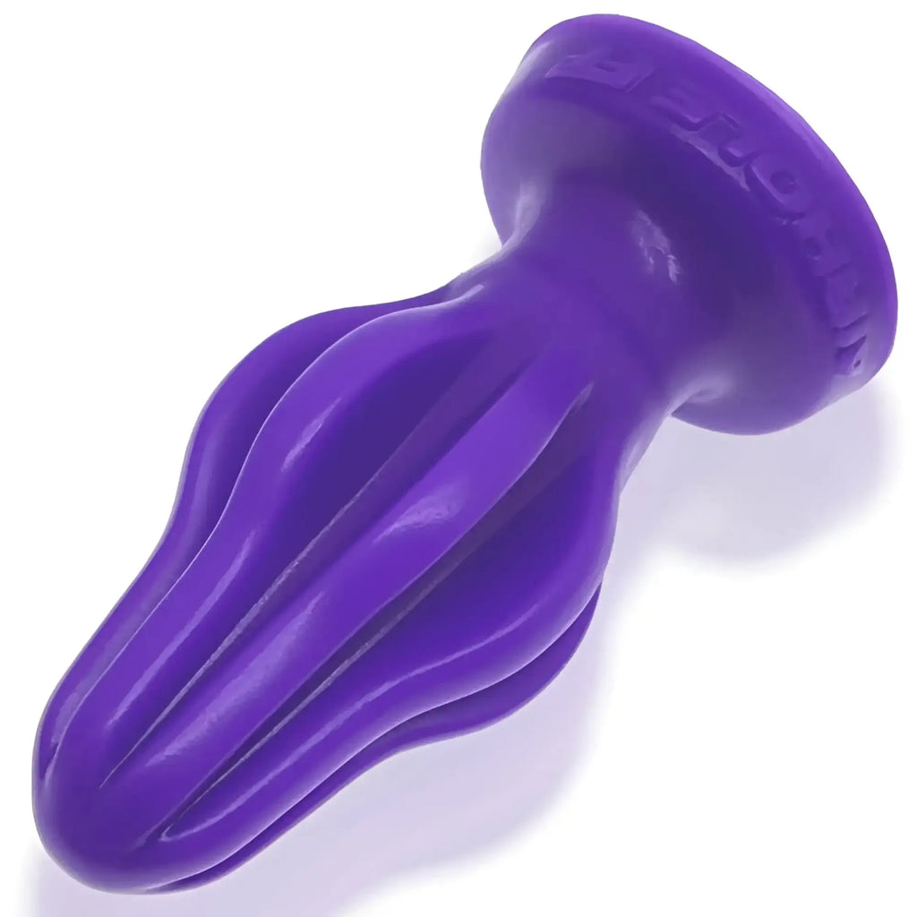 Purple silicone oxballs airhole-2 finned buttplug with tapered fluted design and embossed brand name on the base