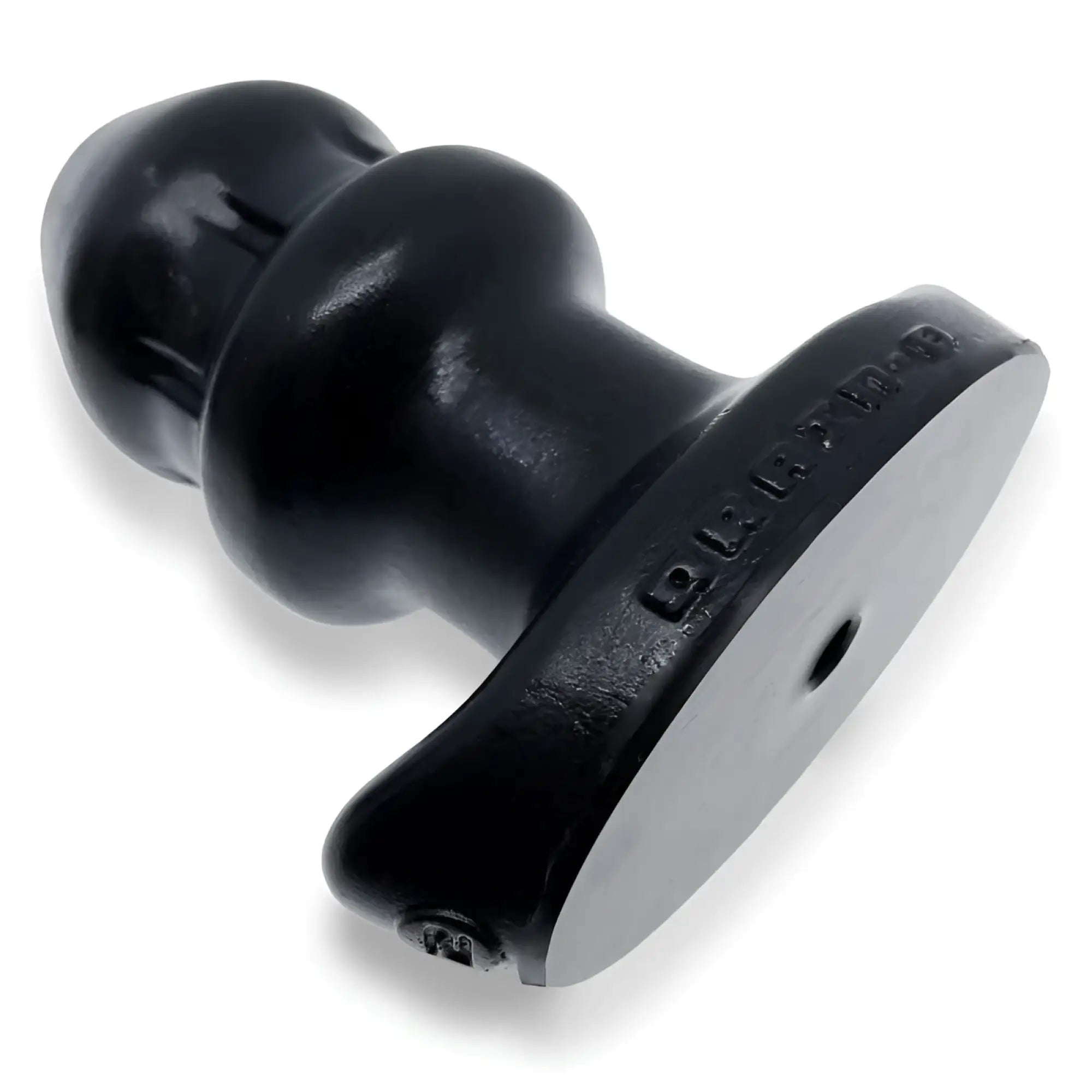 Black rubber stamp with rounded handle and embossed text on side for oxballs drain o flow thru buttplug black s