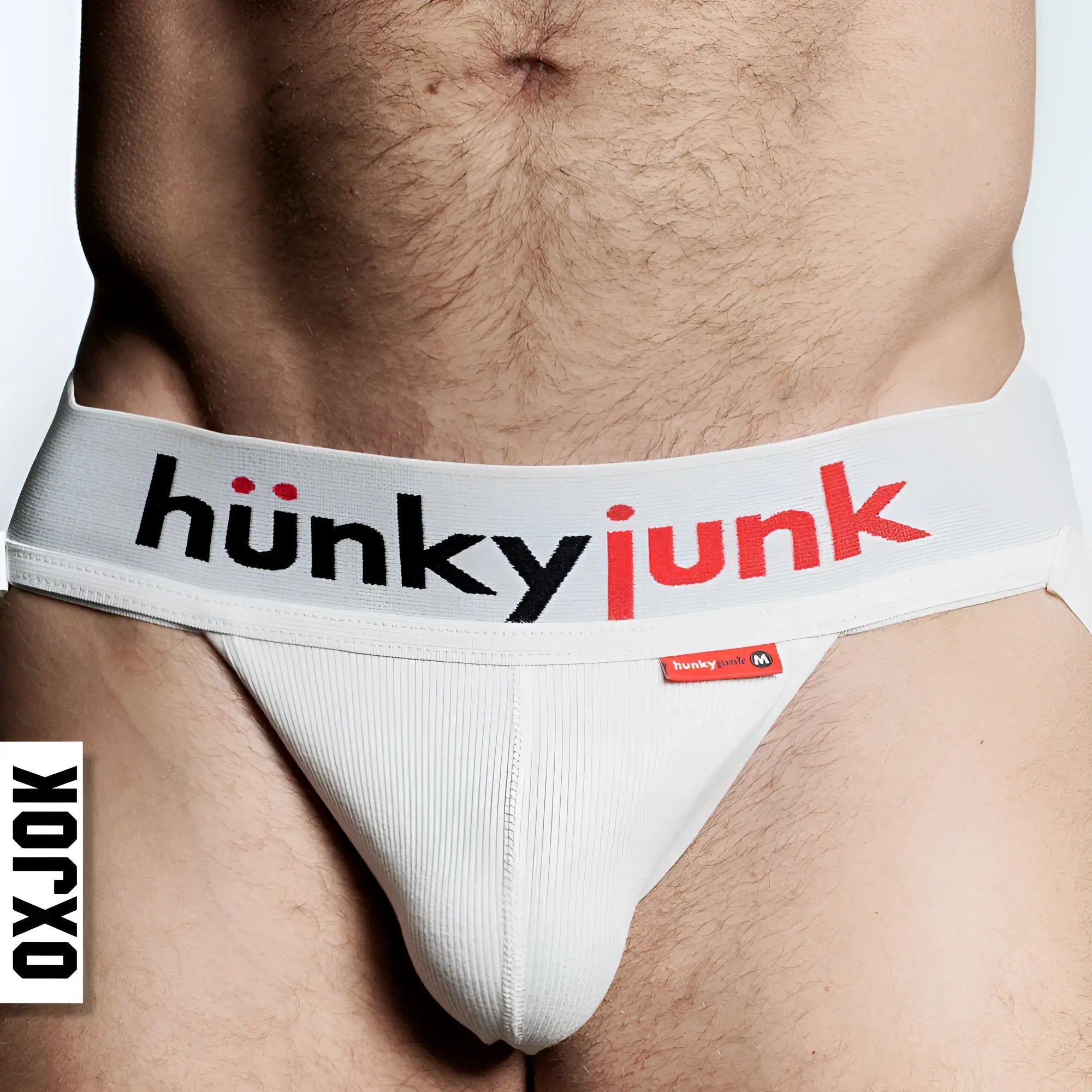 White ribbed briefs with gray waistband featuring hunky junk logo in black and red from oxballs hunker slider strap jock white snow l