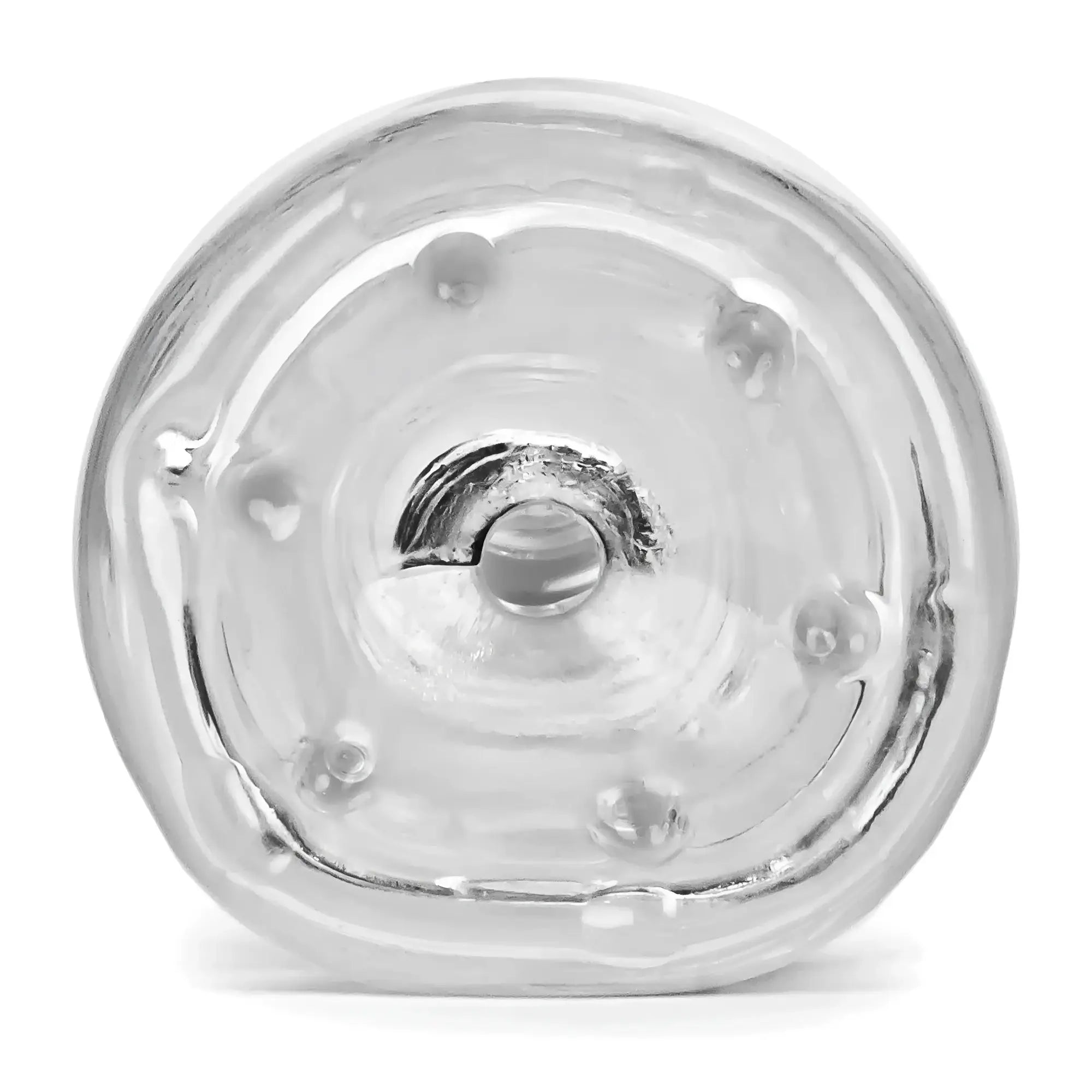 Clear oxballs jerk masturbator glass bottle with textured rounded base and raised bumps around the rim