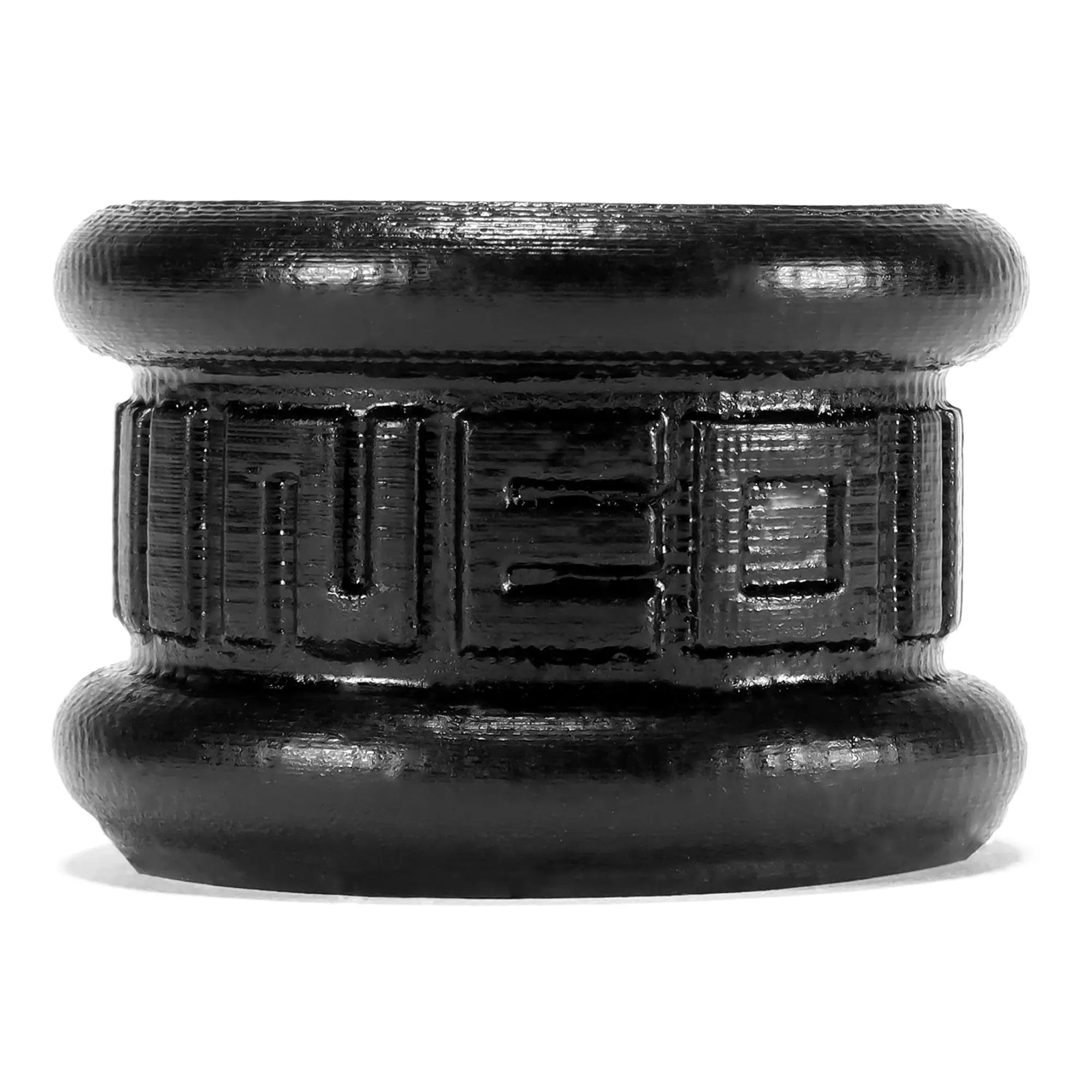 Black cylindrical oxballs neo short ballstretcher with embossed geometric pattern and textured surface