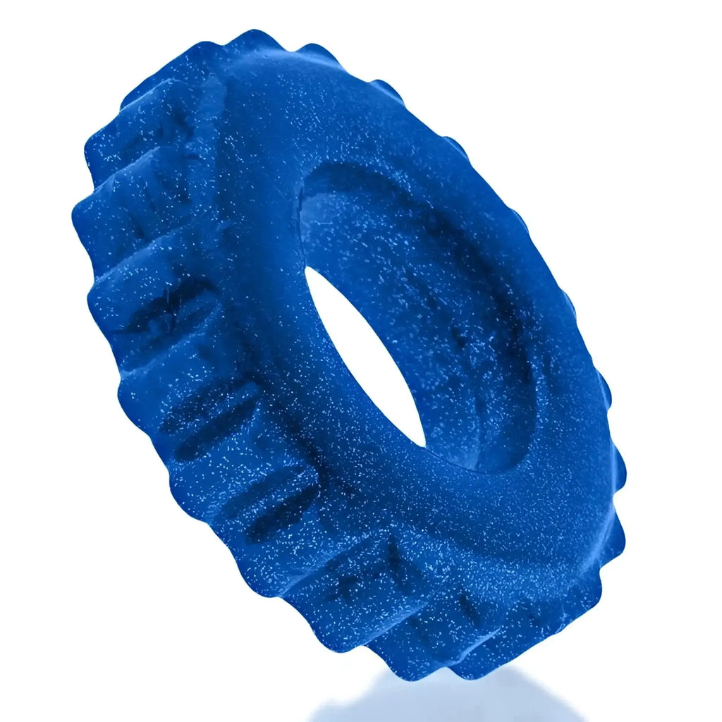 A vibrant blue glittery silicone OxBalls plushy ring with a textured gear-like outer edge in one size