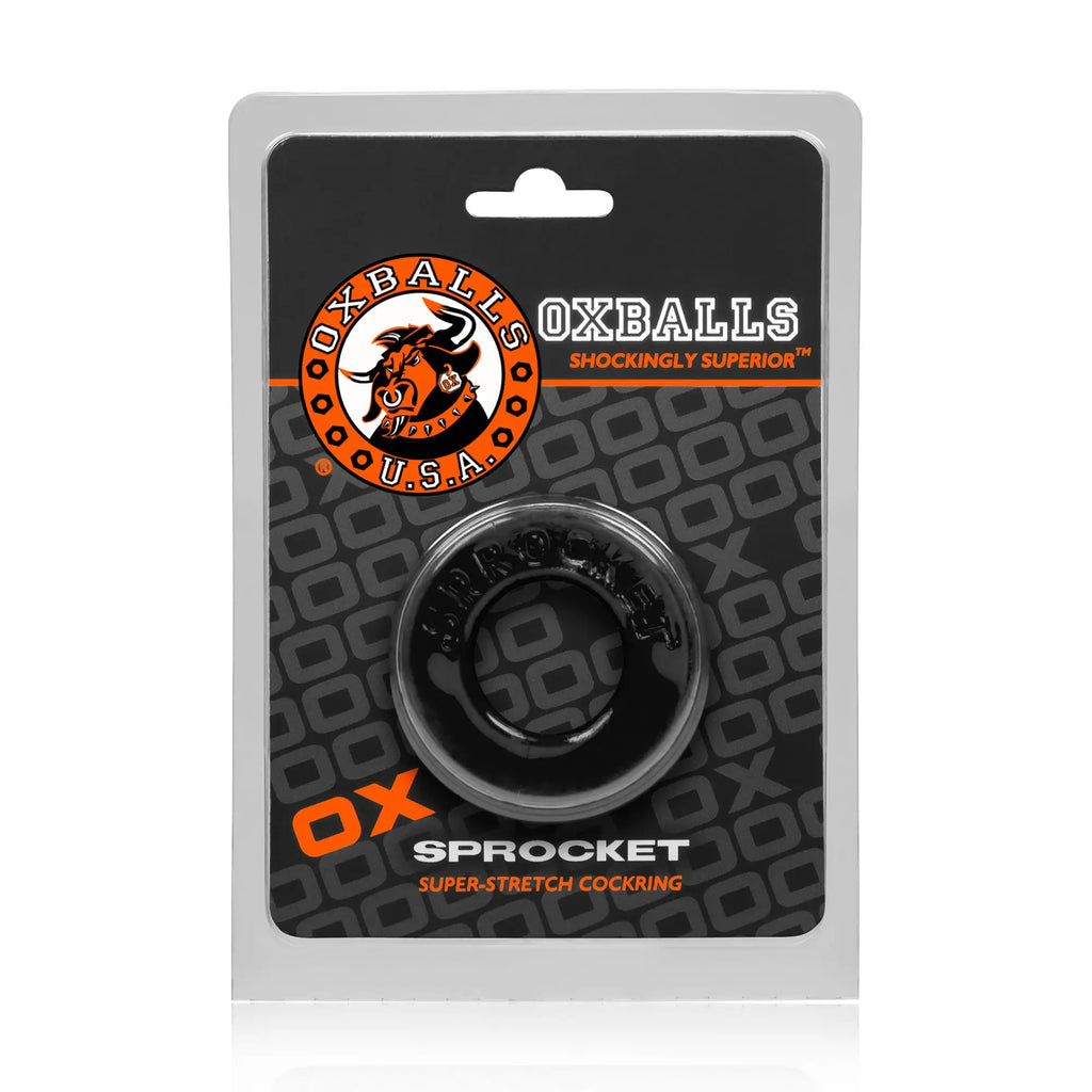 Black oxballs sprocket super-stretch cockring in clear plastic packaging showing the front label and ring details