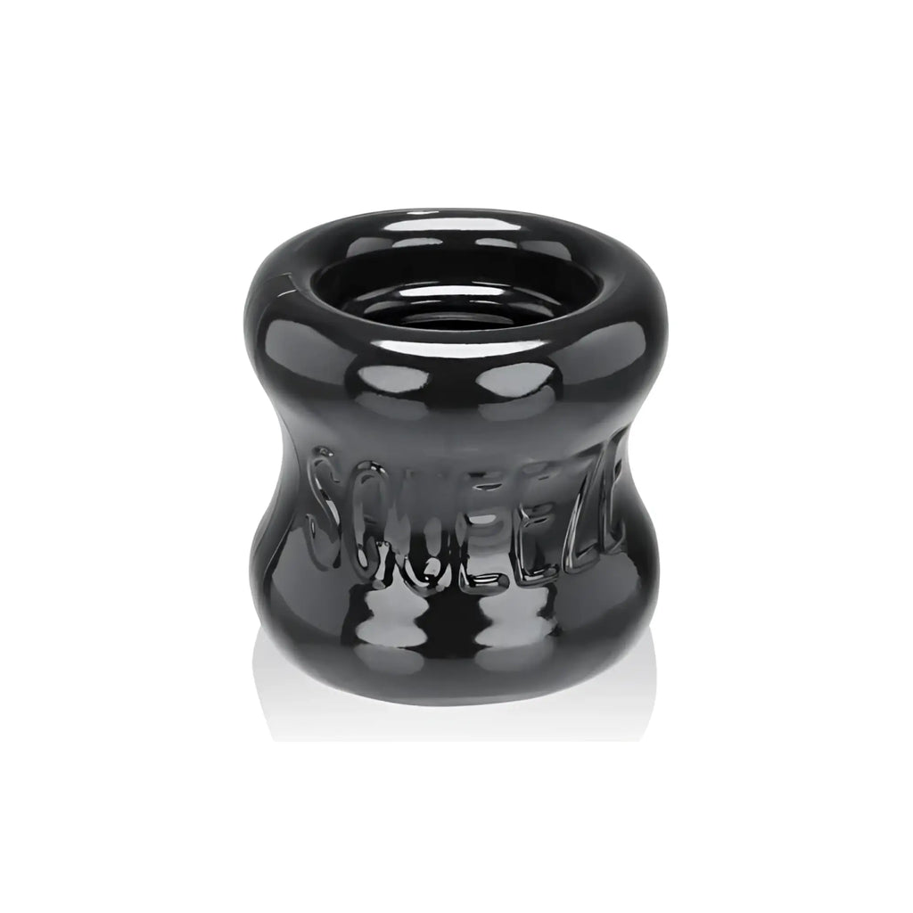 Black glossy silicone squeeze ring with embossed oxballs branding for ball stretcher use