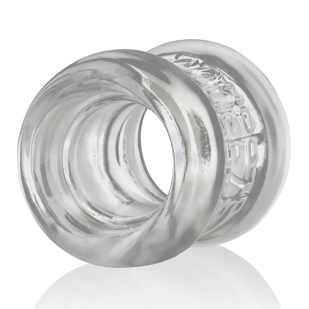 Clear translucent silicone oxballs squeeze ball stretcher with textured outer surface and concentric inner ridges