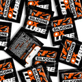 Black and orange silicone lube packets with bold white oxballs branding thick OXLube 50 pack sachets