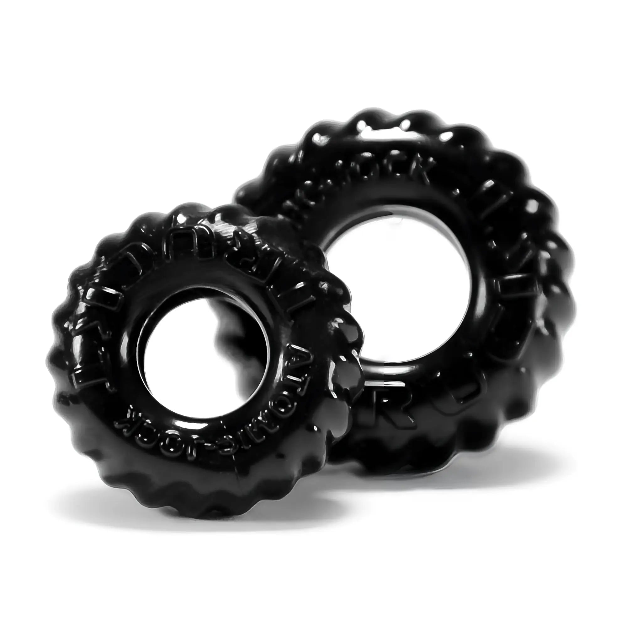 Black glossy tire-shaped silicone cockrings with embossed text from oxballs truckt 2 pc set