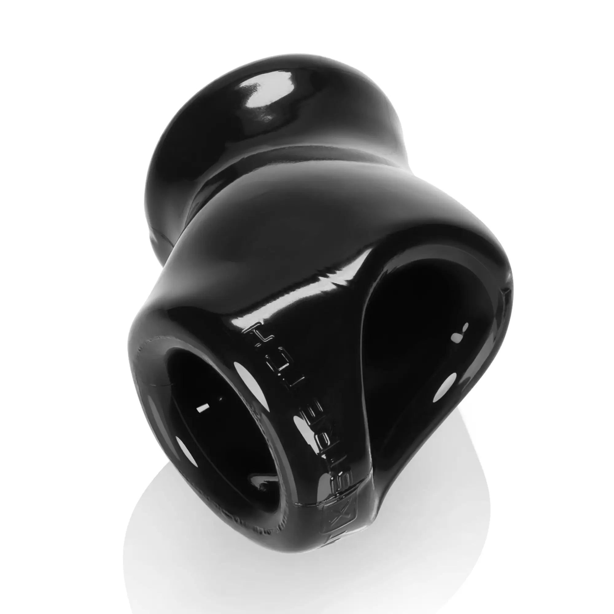 Black glossy silicone anal plug with smooth rounded design and embossed text from oxballs unit x stretch cocksling black