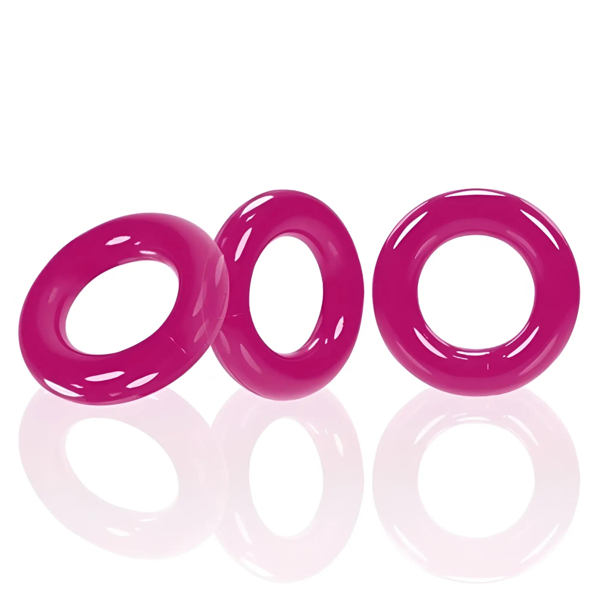 Three vibrant hot pink OxBalls Willy Rings made of glossy silicone designed for male enhancement