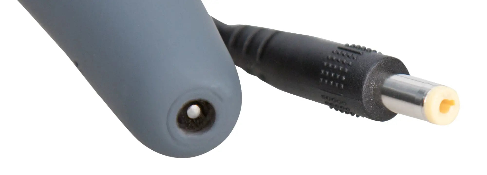 Gray cylindrical back side of palmPower massage wand pink with black dc power connector and yellow insulating ring