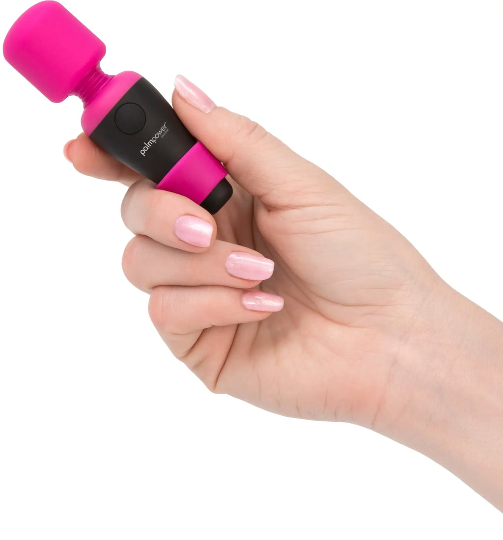 A vibrant pink and black palmpower pocket massage wand with a smooth rounded head for effective vibrato use