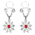 Silver snowflake-shaped nipple clamps with a central red gemstone and clear crystals from peekaboo pasties ruby and diamond star nipple jewellery