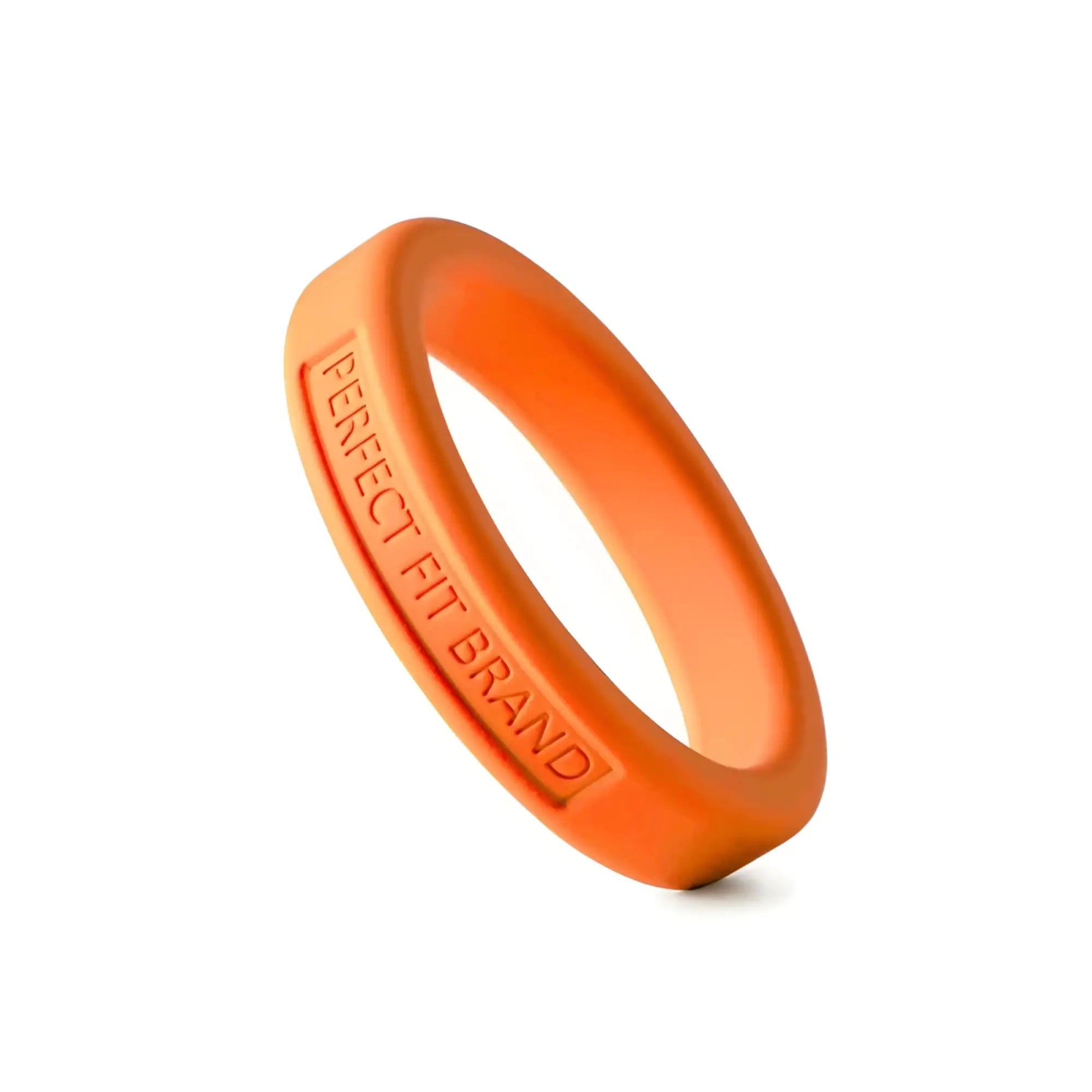 A vibrant orange perfectfit classic silicone medium stretch penis ring with engraved perfect fit brand text inside