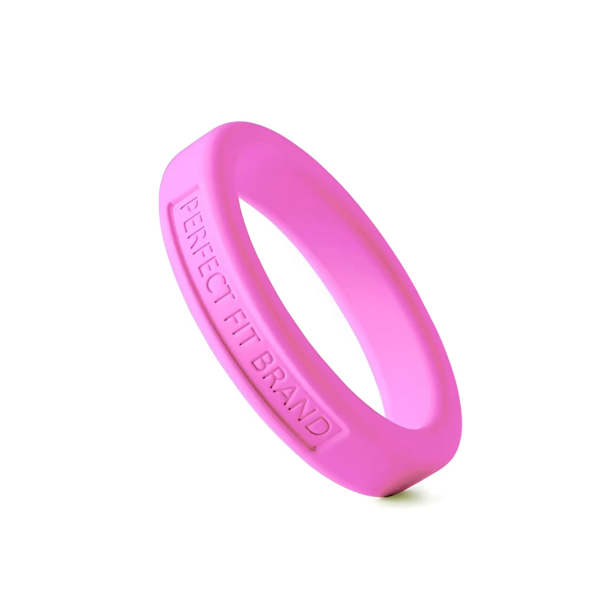A vibrant pink perfectfit classic medium stretch silicone penis ring with engraved perfect fit brand text inside