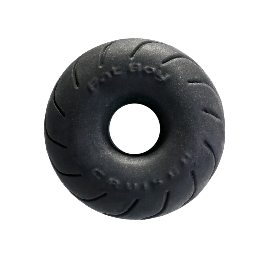 Black rubber donut-shaped PerfectFit Cruiser Ring 2.5in with tire tread pattern and embossed text made of SilaSkin