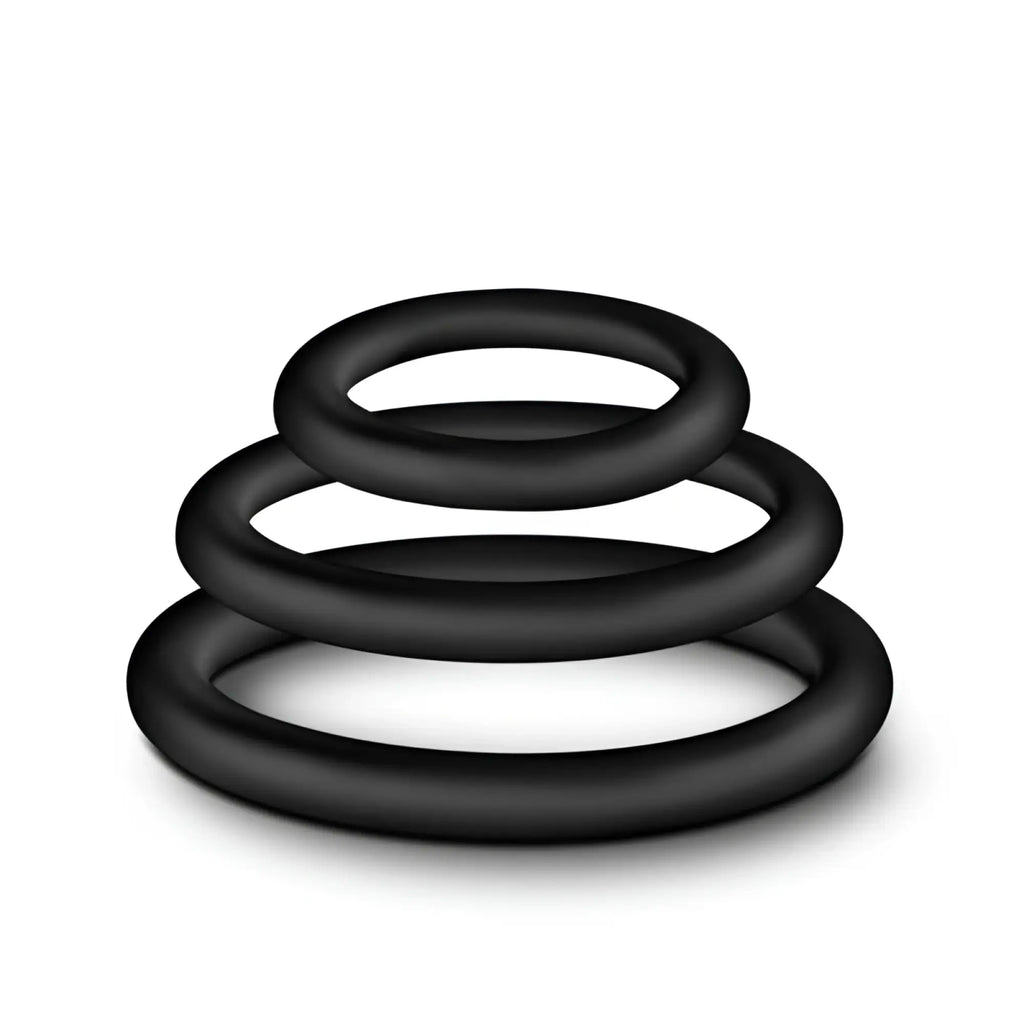 Black silicone performance cock ring set with three graduated sizes stacked in a spiral for performance enhancement