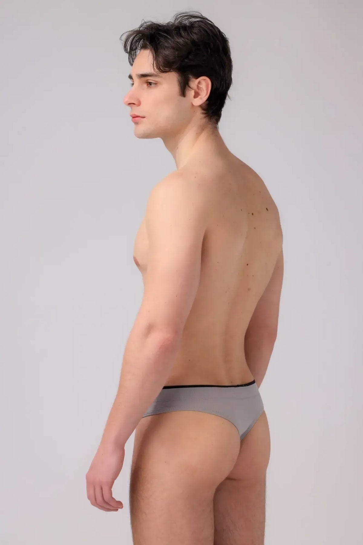 As performance thong gray briefs with thin black waistband showing front side in breathable fabric
