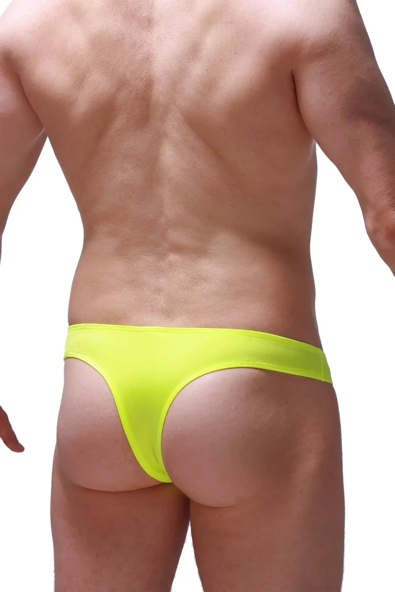 Bright neon yellow petitq bikini capri joe thong made of smooth stretchy fabric shown from the front