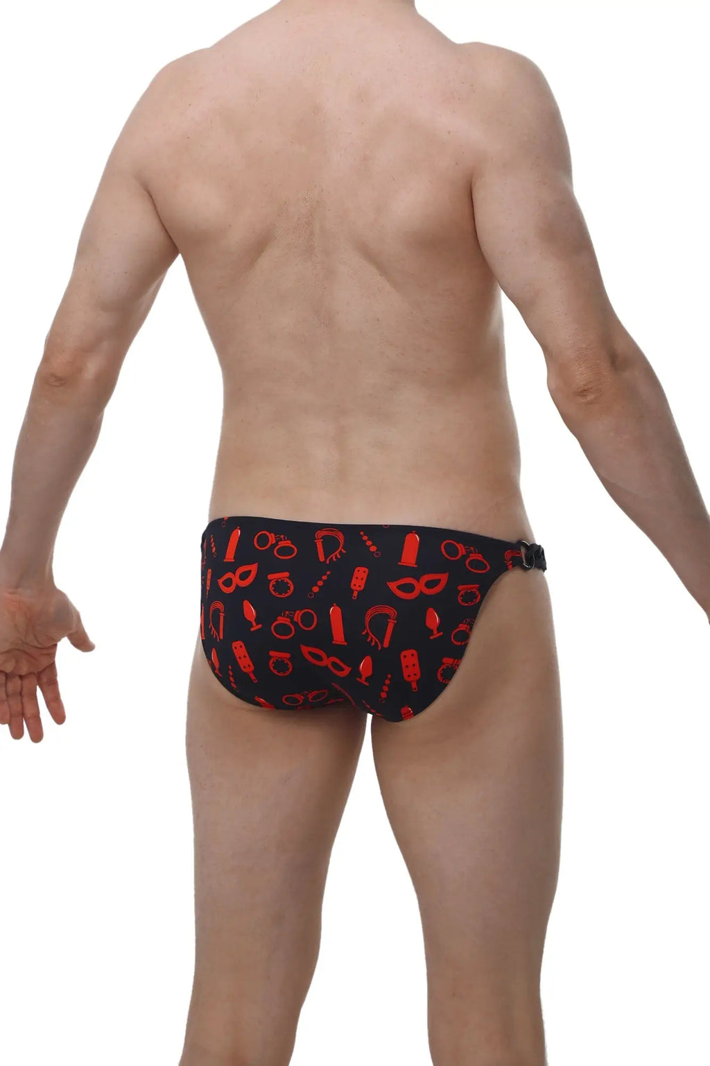 Black swim trunks from petitq bikini chains boudoir with red playful symbols printed across the fabric