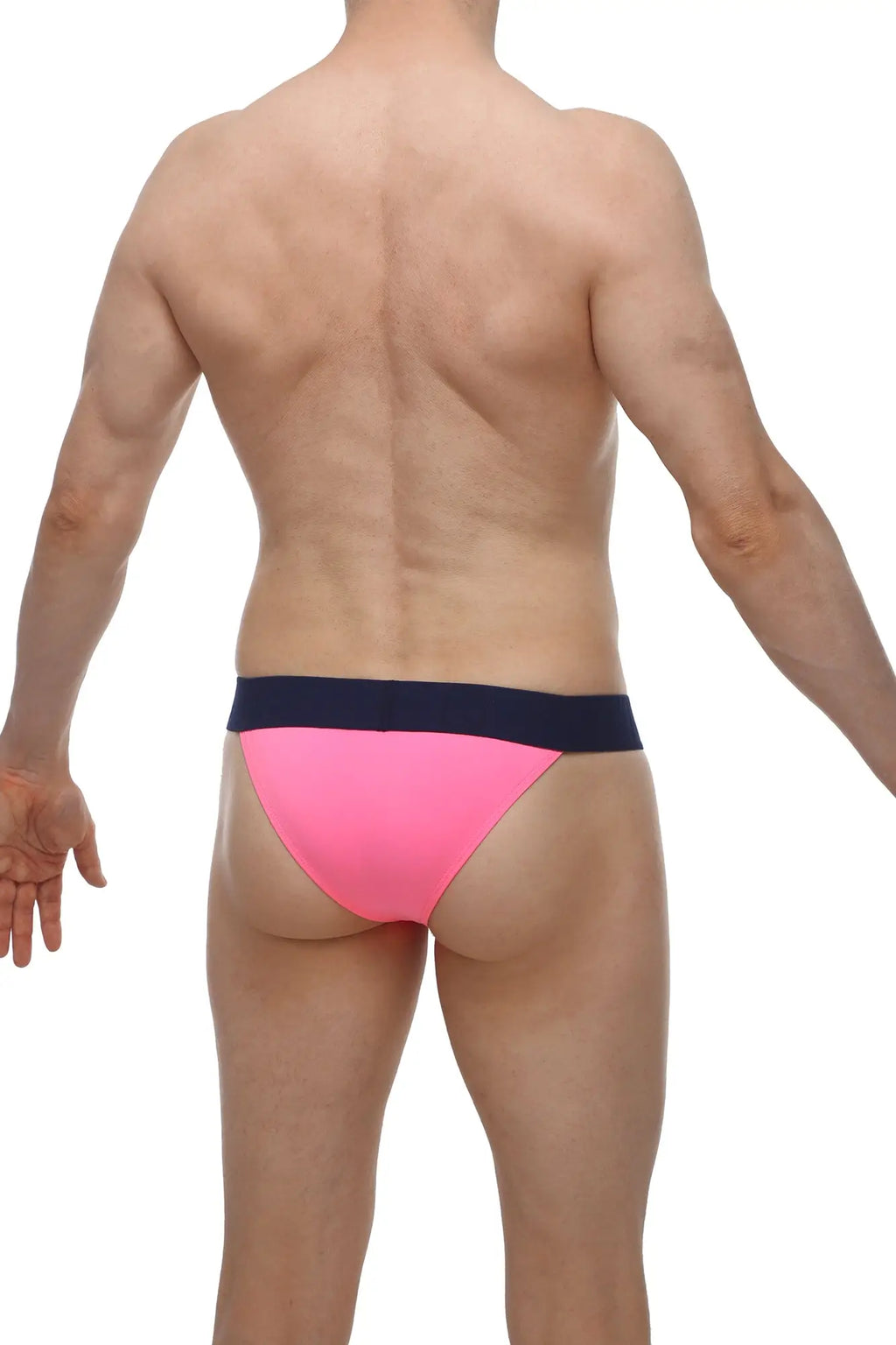Bright pink PetitQ bikini Coren pink swim trunks with a contrasting navy blue waistband for beachwear