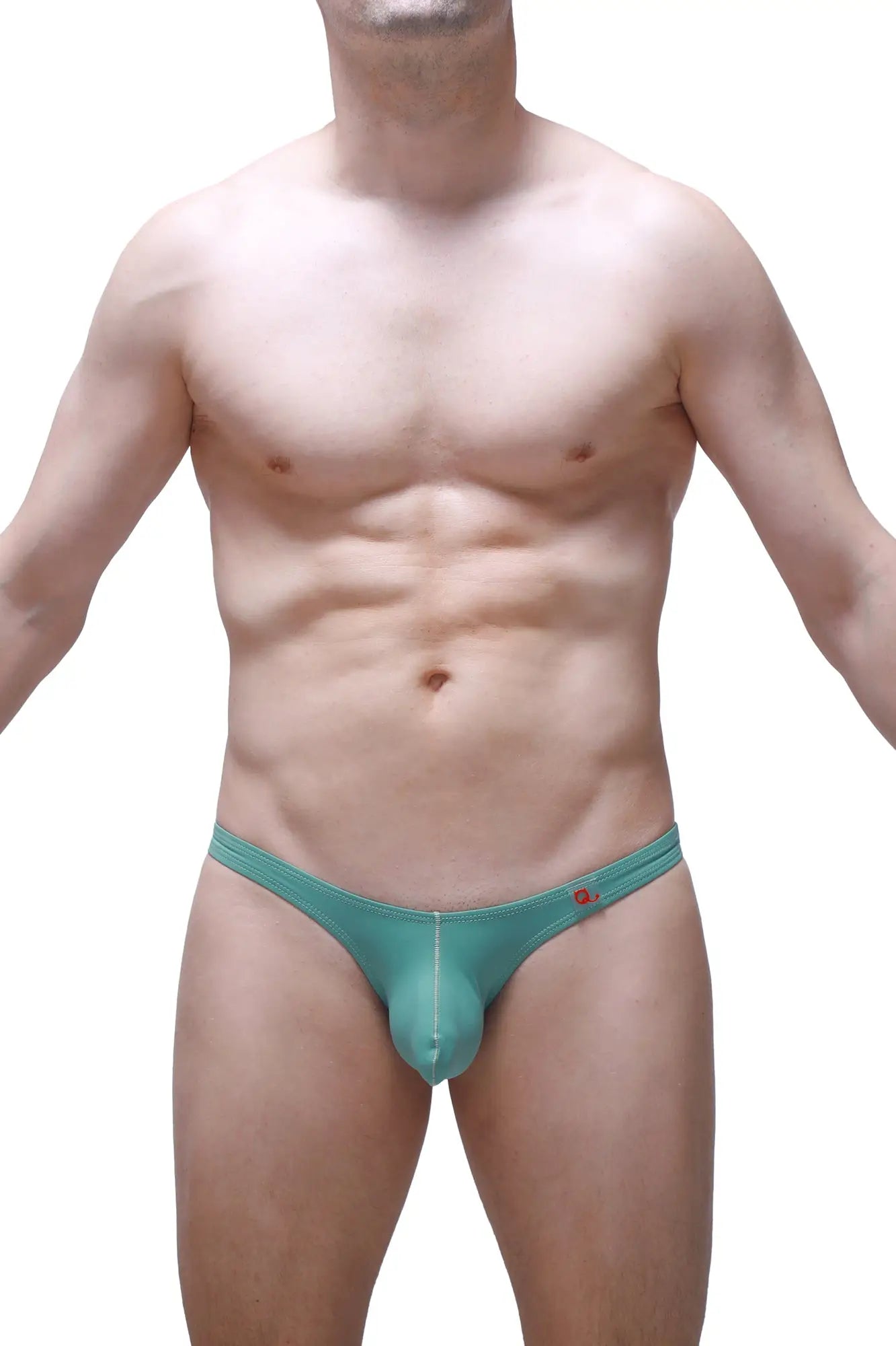 Teal-colored form-fitting men’s thong with subtle seam detail and small red logo on waistband petitq bikini dome green